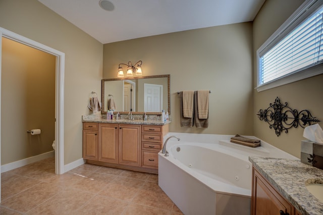 bathroom with toilet, vanity, tile patterned floors, and a bathtub