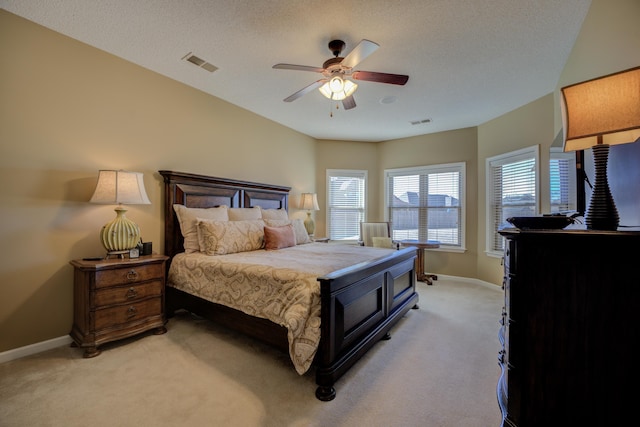 carpeted bedroom with a textured ceiling and ceiling fan