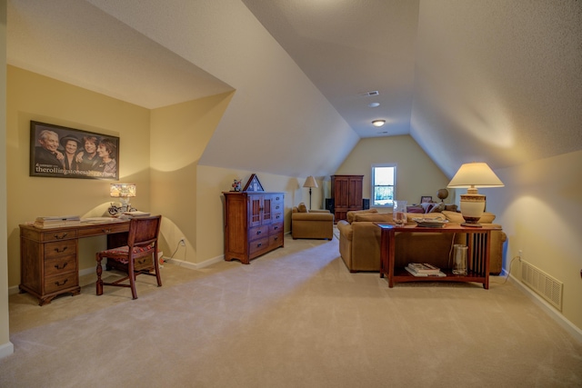 carpeted home office with lofted ceiling