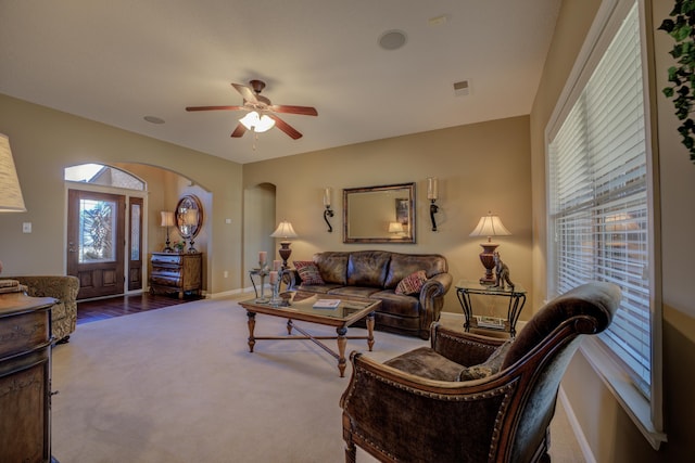 carpeted living room featuring ceiling fan