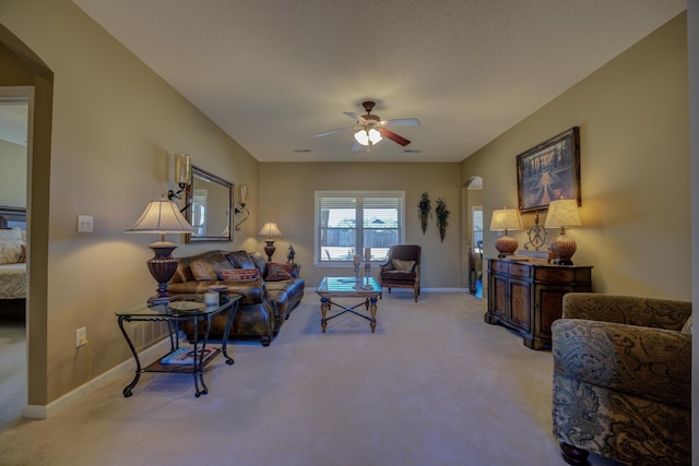 living room featuring ceiling fan and light colored carpet