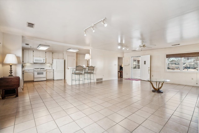 tiled living room featuring ceiling fan