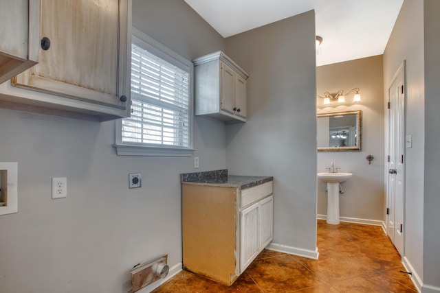 laundry area featuring washer hookup, cabinets, light tile patterned flooring, and electric dryer hookup