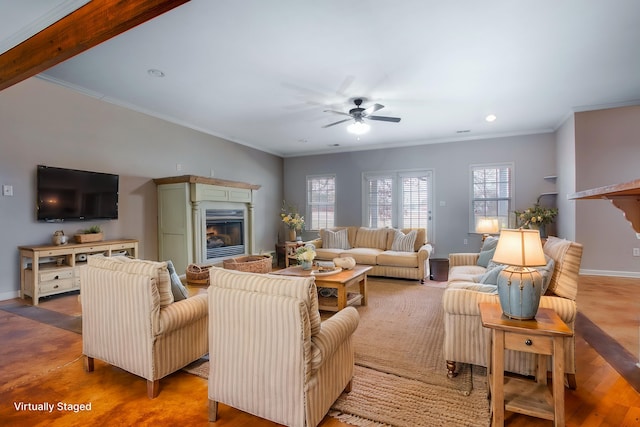 living room featuring ornamental molding and ceiling fan