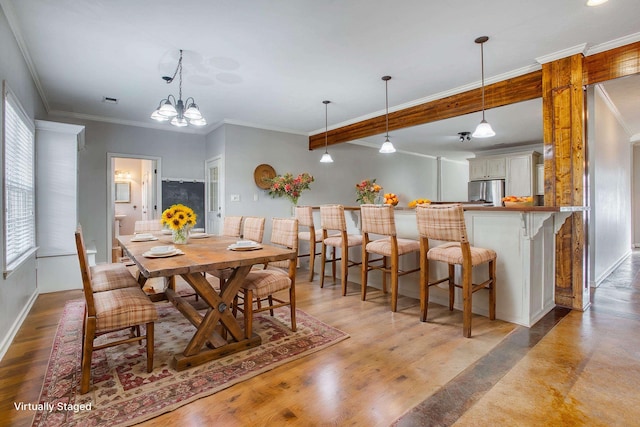 dining space with a chandelier, beam ceiling, crown molding, and light hardwood / wood-style flooring