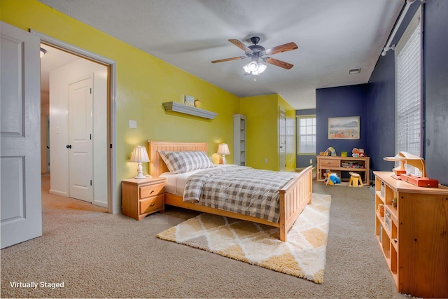 bedroom with ceiling fan and light colored carpet