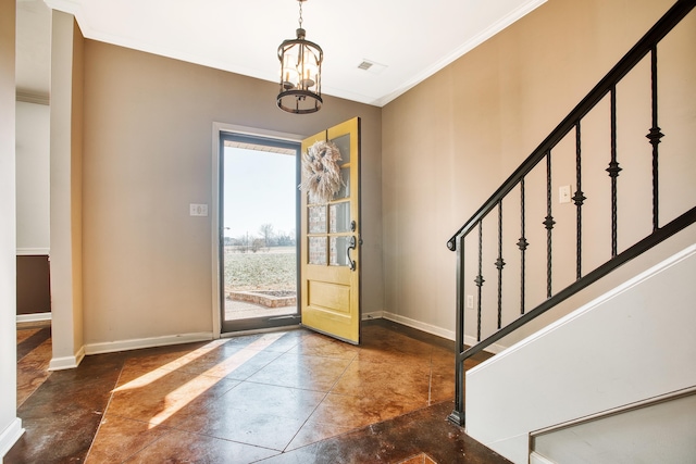 foyer featuring ornamental molding and a notable chandelier