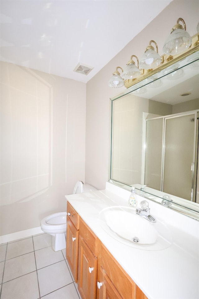 bathroom featuring a shower with door, vanity, tile patterned floors, and toilet