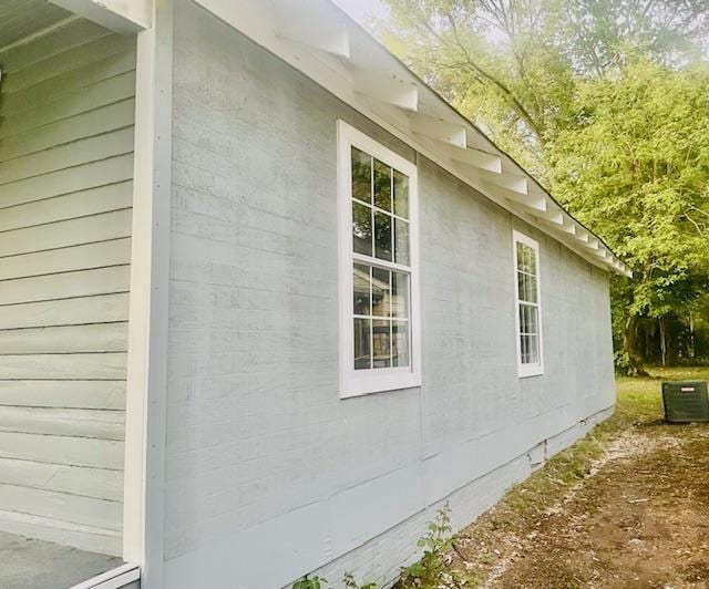 view of side of property featuring central AC