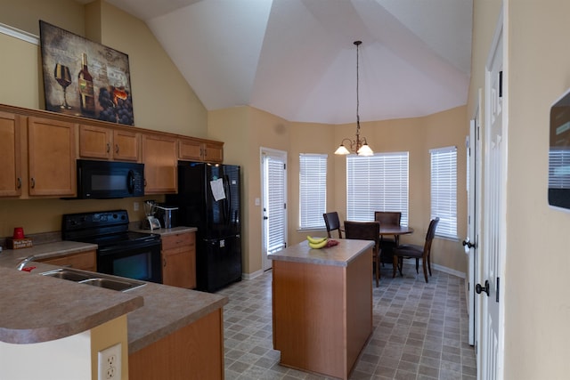 kitchen with a center island, sink, a chandelier, decorative light fixtures, and black appliances