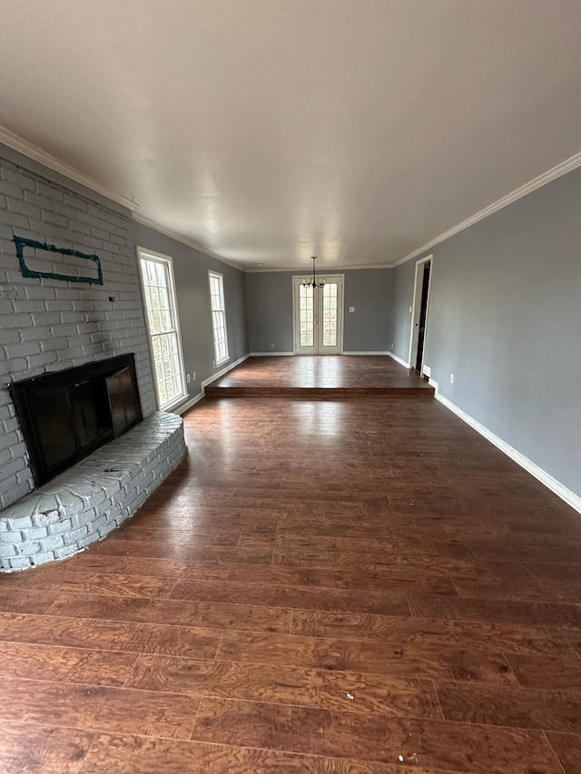 unfurnished living room with ornamental molding and a fireplace