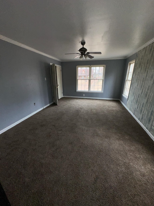 empty room featuring crown molding, carpet floors, and ceiling fan