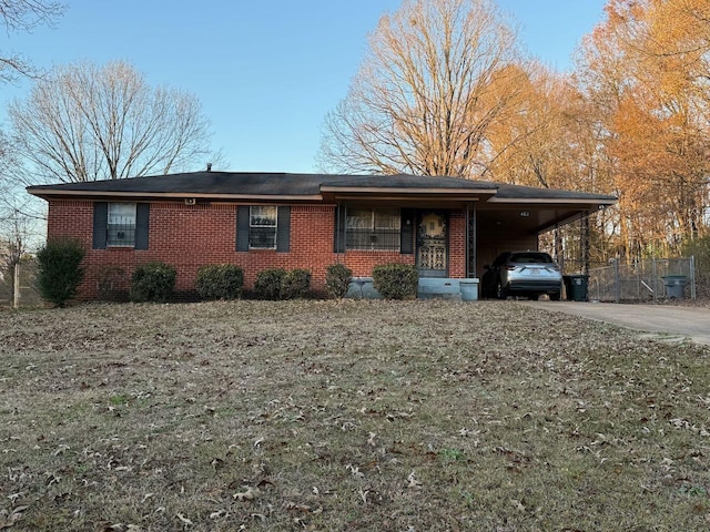 single story home with a carport, brick siding, and driveway