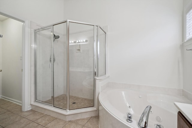 bathroom featuring tile patterned flooring, shower with separate bathtub, and vanity