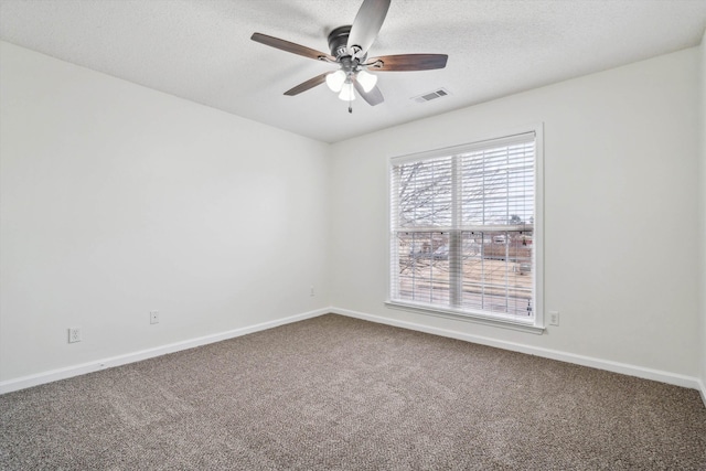 empty room with carpet flooring, a textured ceiling, and ceiling fan