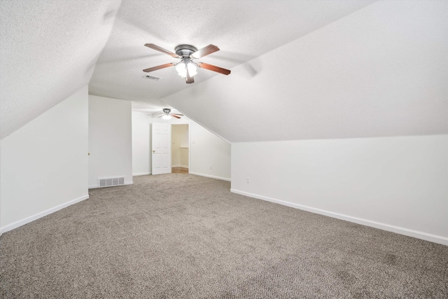 additional living space featuring carpet flooring, ceiling fan, a textured ceiling, and vaulted ceiling