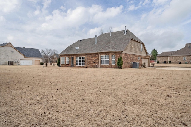 rear view of property featuring central AC unit