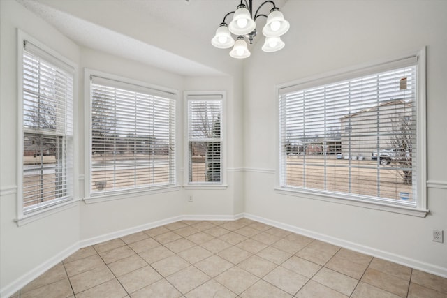 interior space with light tile patterned floors and a chandelier