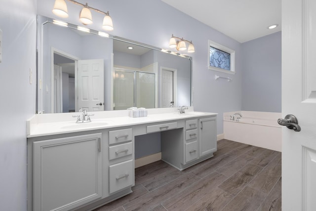 bathroom with vanity and separate shower and tub