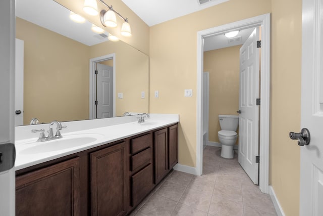 bathroom with tile patterned floors, vanity, and toilet