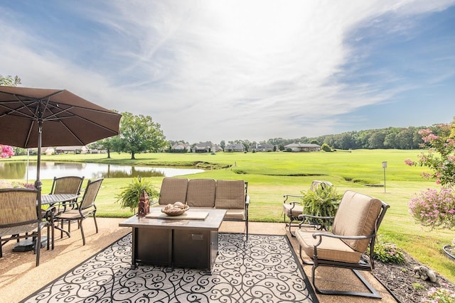 view of patio featuring a water view and an outdoor living space with a fire pit