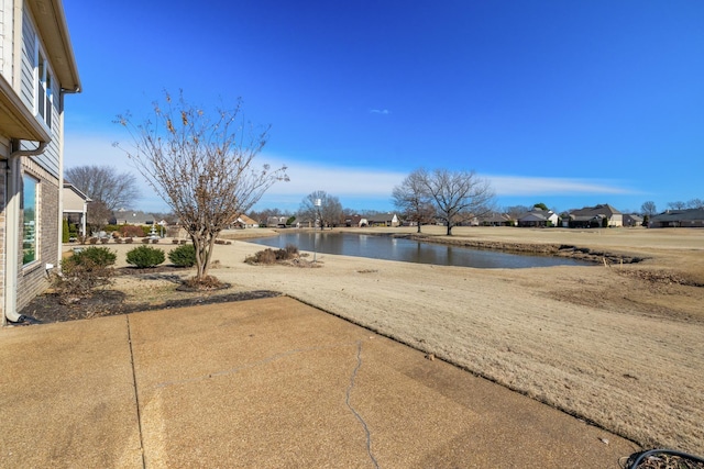 view of yard featuring a patio area and a water view