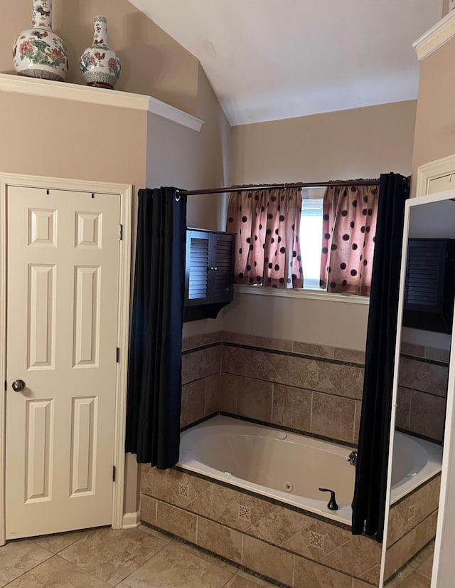 bathroom with tile patterned floors and tiled tub