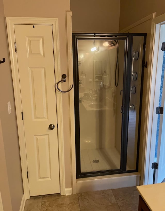 bathroom featuring vanity and an enclosed shower