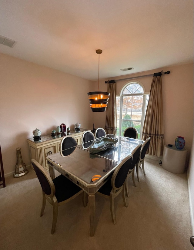 dining room featuring light colored carpet