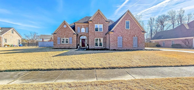 tudor home featuring a front lawn