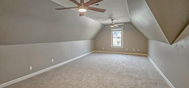 bonus room with ceiling fan, light colored carpet, and vaulted ceiling