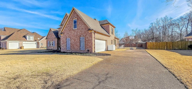 view of side of property featuring a yard and a garage