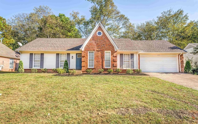 view of front of home with a front yard and a garage