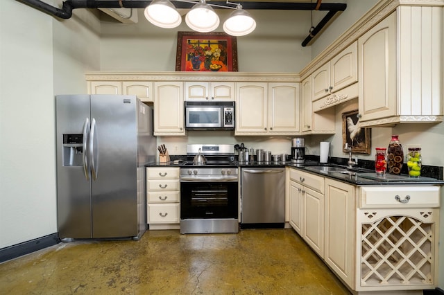 kitchen with sink, appliances with stainless steel finishes, and cream cabinets