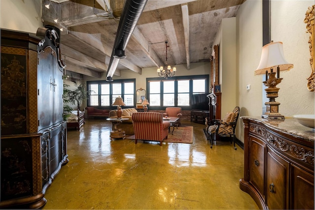 living room featuring a chandelier and concrete flooring