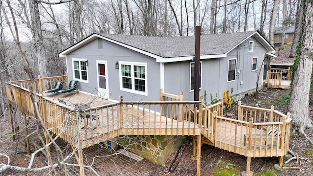 back of property featuring a wooden deck