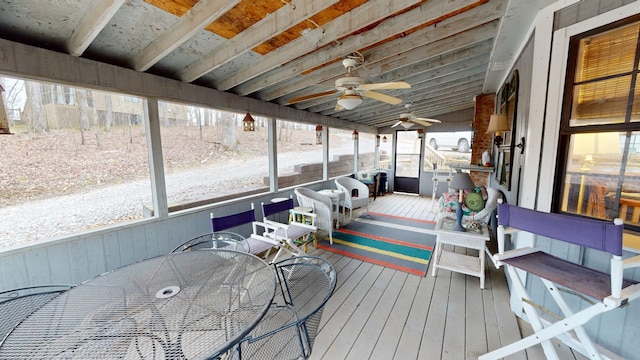 sunroom featuring ceiling fan and vaulted ceiling