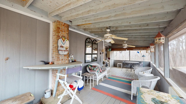 sunroom featuring vaulted ceiling with beams and ceiling fan