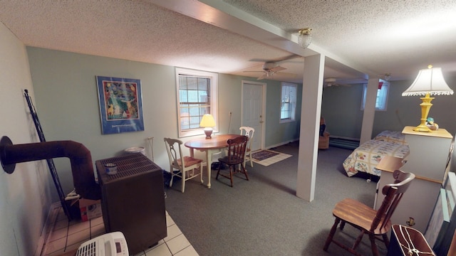 interior space featuring a wealth of natural light, ceiling fan, light tile patterned flooring, and a textured ceiling