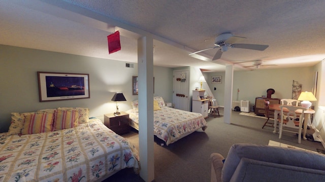 bedroom featuring ceiling fan, light colored carpet, and a textured ceiling