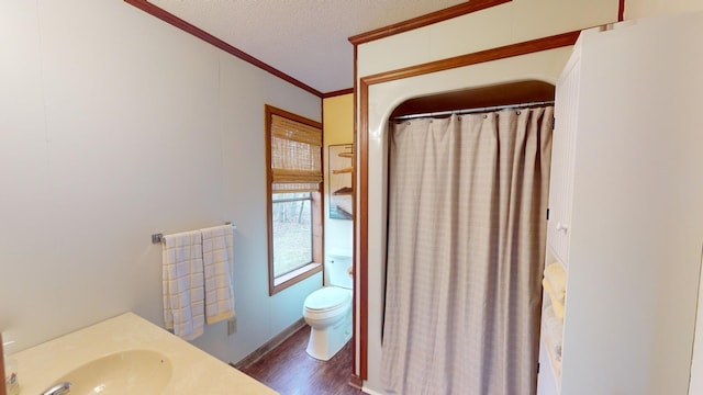 bathroom with sink, ornamental molding, a textured ceiling, toilet, and hardwood / wood-style flooring