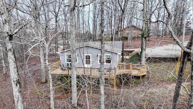 rear view of house featuring a deck