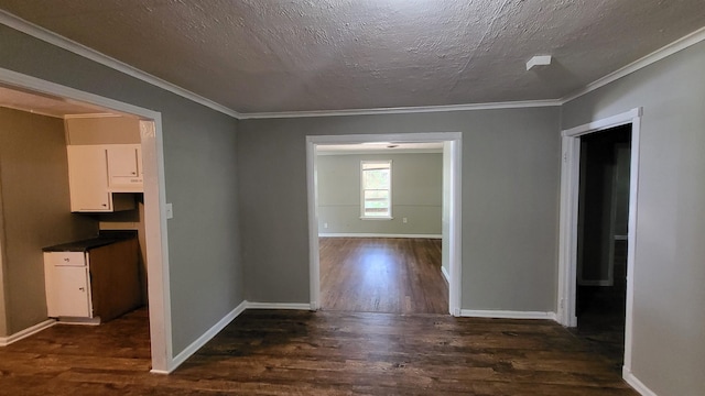 hall featuring a textured ceiling, crown molding, and dark hardwood / wood-style floors