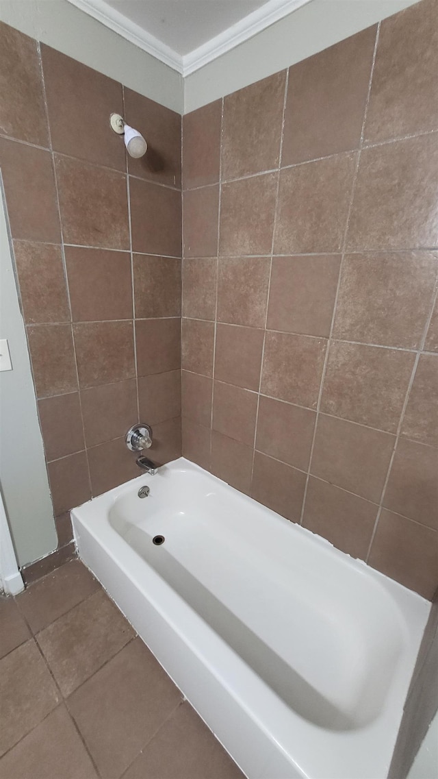 bathroom featuring tile patterned flooring, ornamental molding, and bathing tub / shower combination