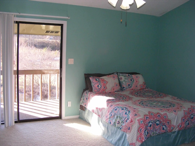 carpeted bedroom with multiple windows, access to outside, and ceiling fan