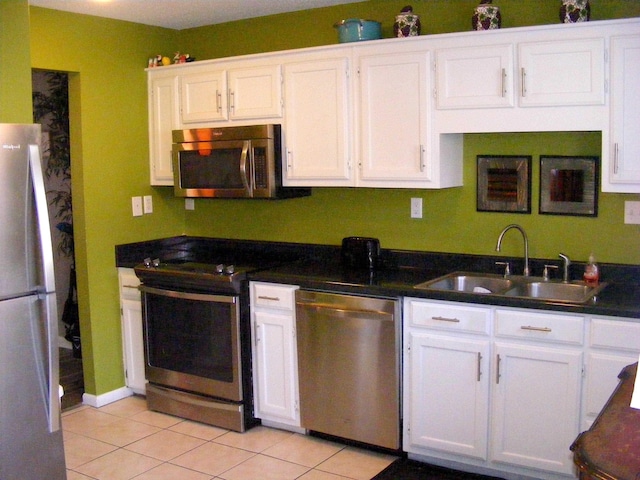 kitchen featuring appliances with stainless steel finishes, sink, and white cabinets