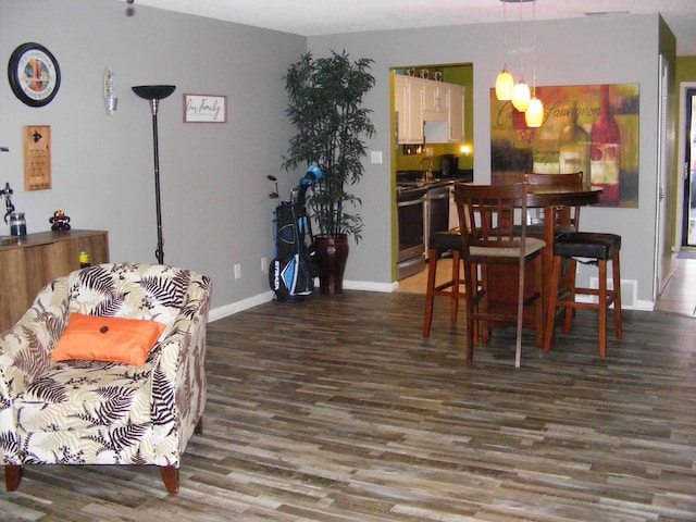 dining space with sink and dark hardwood / wood-style floors