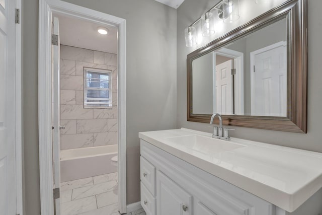 full bathroom with vanity, tiled shower / bath combo, and toilet