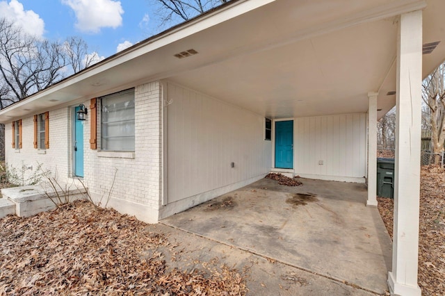 view of exterior entry with a carport