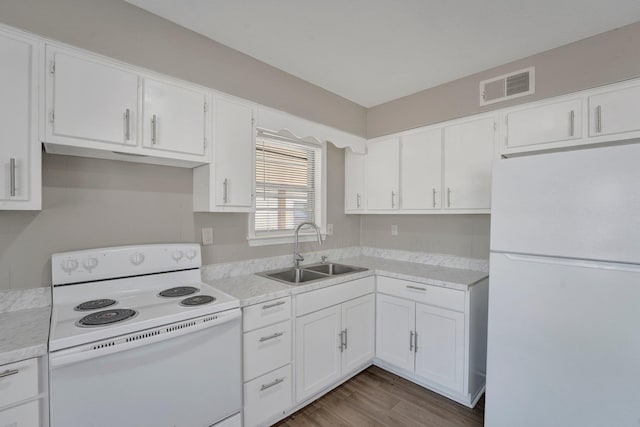 kitchen with white cabinets, white appliances, and sink